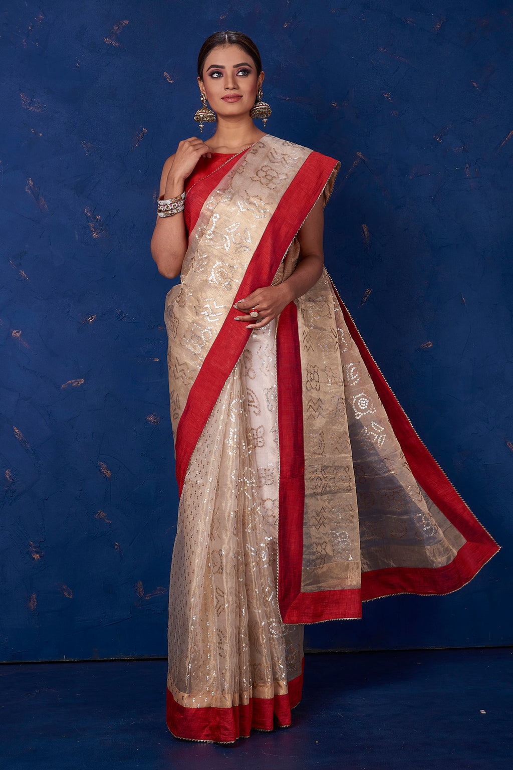 Shop stunning beige foil print organza sari online in USA with red border. Keep your ethnic wardrobe with exclusive designer sarees, handloom sarees, pure silk sarees, soft silk sarees, Banarasi silk sarees from Pure Elegance Indian fashion store in USA.-full view