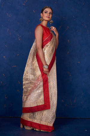 Shop stunning beige foil print organza sari online in USA with red border. Keep your ethnic wardrobe with exclusive designer sarees, handloom sarees, pure silk sarees, soft silk sarees, Banarasi silk sarees from Pure Elegance Indian fashion store in USA.-side