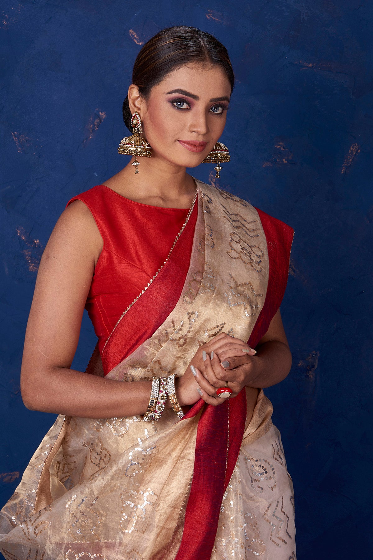 Shop stunning beige foil print organza sari online in USA with red border. Keep your ethnic wardrobe with exclusive designer sarees, handloom sarees, pure silk sarees, soft silk sarees, Banarasi silk sarees from Pure Elegance Indian fashion store in USA.-closeup