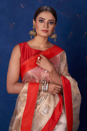 Buy gorgeous beige foil print organza saree online in USA with solid red border. Keep your ethnic wardrobe with exclusive designer sarees, handloom sarees, pure silk sarees, soft silk sarees, Banarasi silk sarees from Pure Elegance Indian fashion store in USA.-closeup