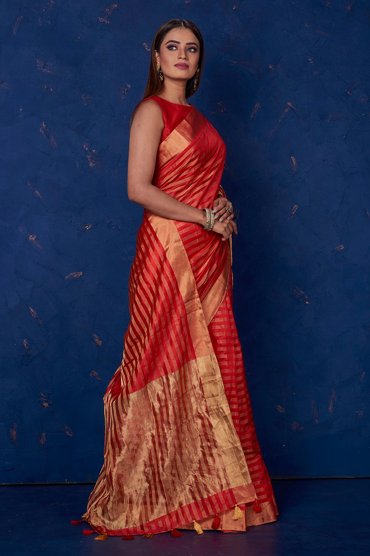 Buy stunning red striped tussar sari online in USA with golden zari border. Keep your ethnic wardrobe up to date with latest designer sarees, pure silk sarees, handwoven sarees, tussar silk sarees, embroidered sarees from Pure Elegance Indian saree store in USA.-right