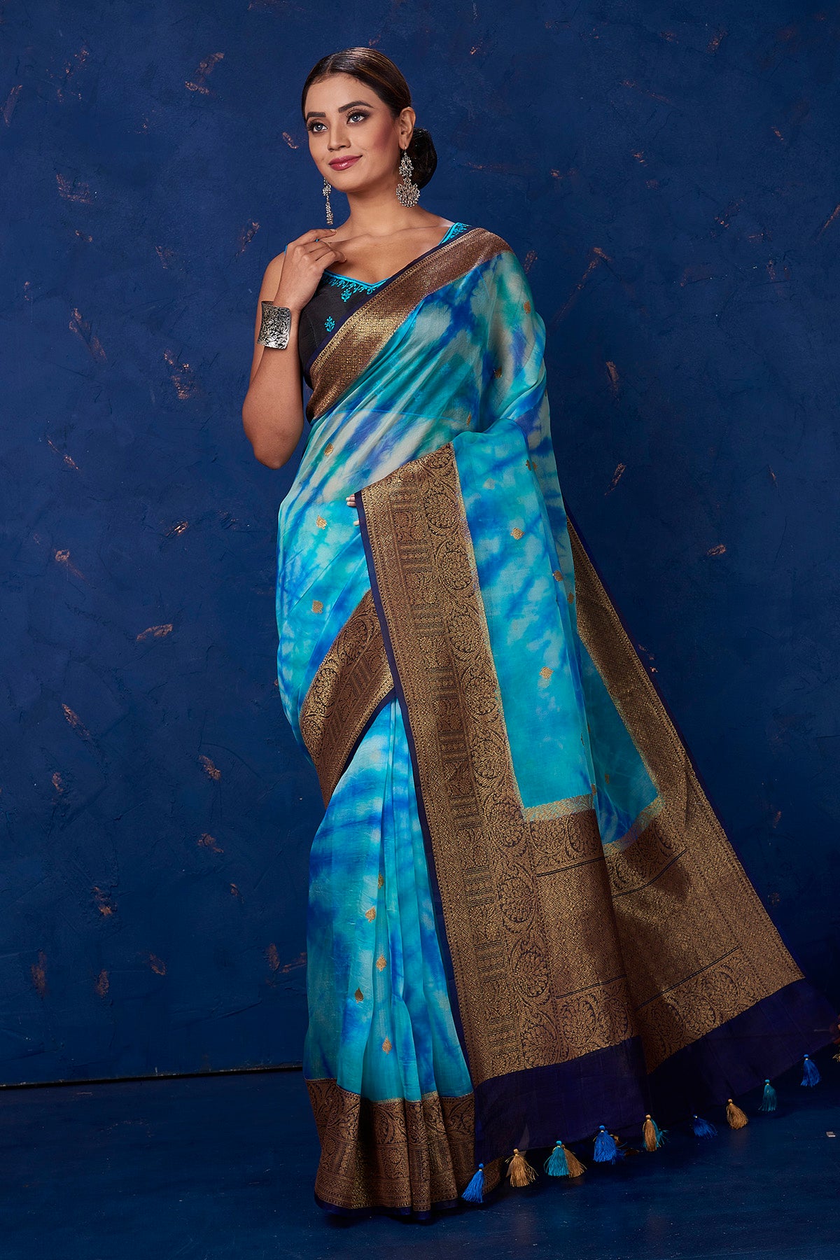 Buy beautiful blue Kora Banarasi saree online in USA with zari border. Keep your ethnic wardrobe up to date with latest designer sarees, pure silk sarees, handwoven sarees, tussar silk sarees, embroidered sarees from Pure Elegance Indian saree store in USA.-full view