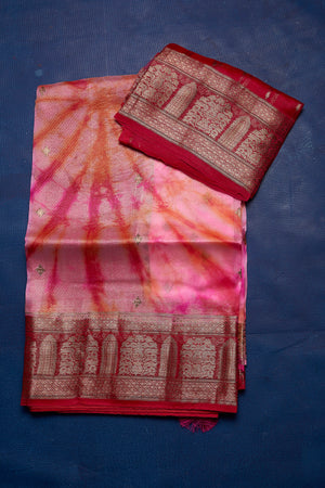 Buy beautiful pink tie and dye Kora Banarasi saree online in USA with red zari border. Keep your ethnic wardrobe up to date with latest designer sarees, pure silk sarees, handwoven sarees, tussar silk sarees, embroidered sarees from Pure Elegance Indian saree store in USA.-blouse