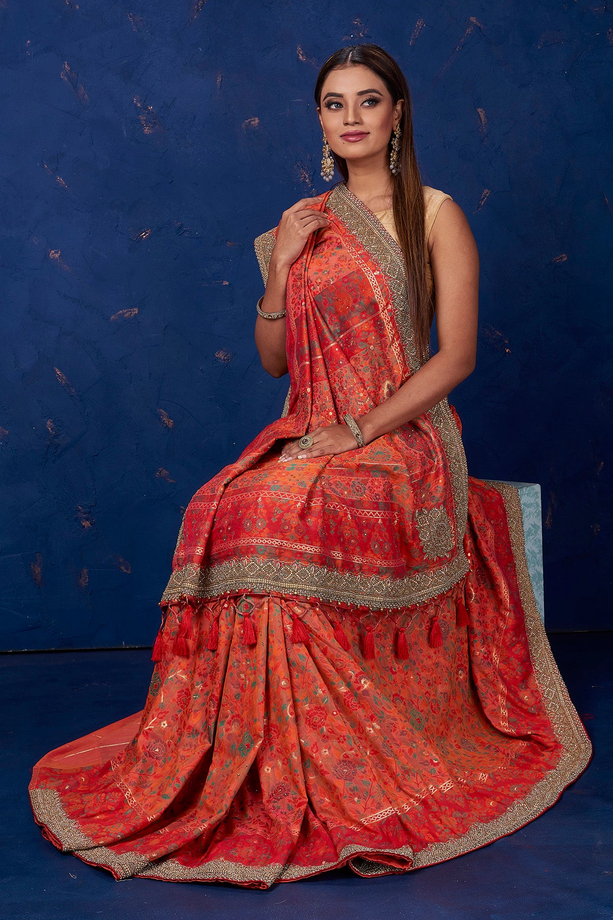 Shop beautiful orange Kani weave saree online in USA with antique work. Keep your ethnic wardrobe up to date with latest designer sarees, pure silk sarees, handwoven sarees, tussar silk sarees, embroidered sarees from Pure Elegance Indian saree store -sitting