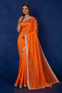 Buy beautiful orange bandhej chanderi saree online in USA with embroidered border. Keep your ethnic wardrobe up to date with latest designer sarees, pure silk sarees, handwoven sarees, tussar silk sarees, embroidered sarees from Pure Elegance Indian saree store in USA.-full view