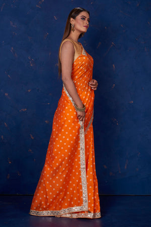 Buy beautiful orange bandhej chanderi saree online in USA with embroidered border. Keep your ethnic wardrobe up to date with latest designer sarees, pure silk sarees, handwoven sarees, tussar silk sarees, embroidered sarees from Pure Elegance Indian saree store in USA.-side