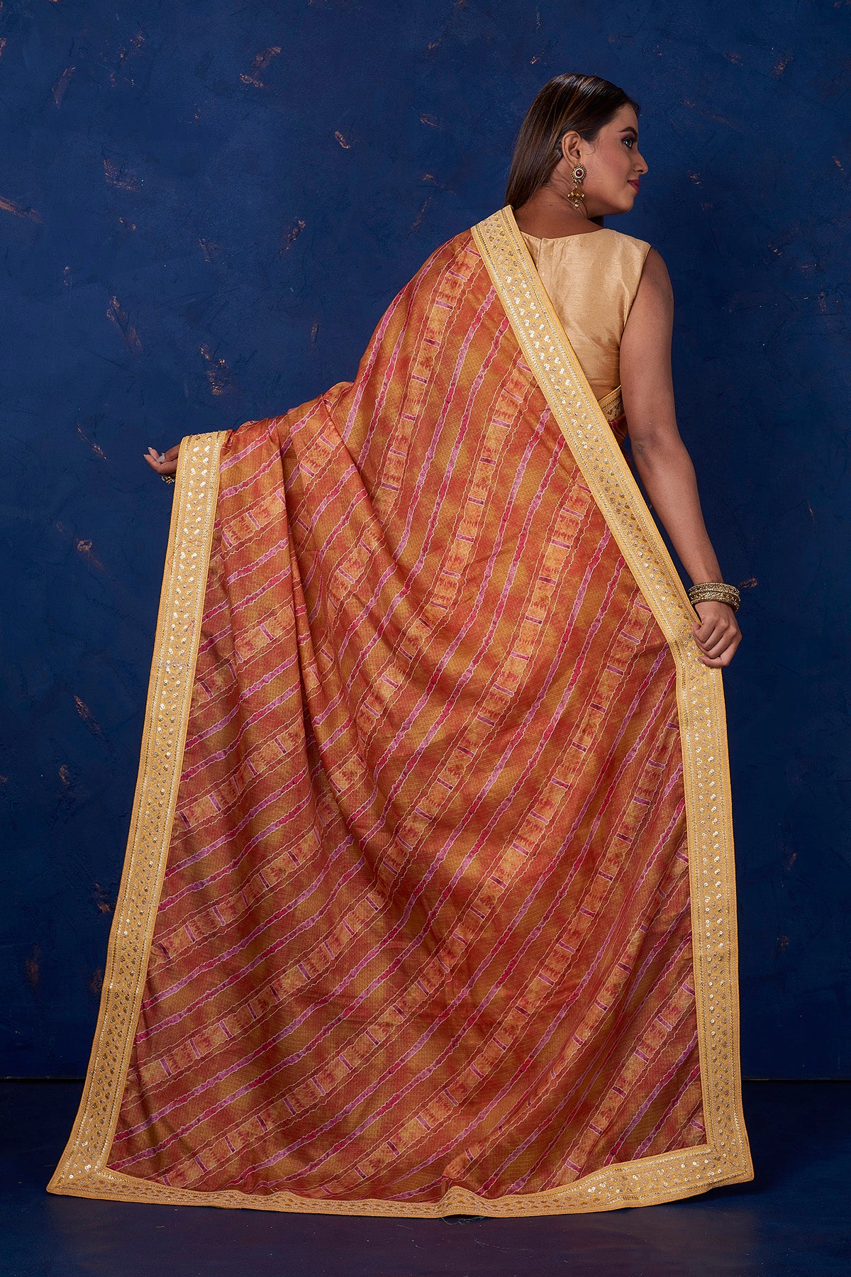 Buy beautiful brown printed Kota saree online in USA with embroidered border. Keep your ethnic wardrobe up to date with latest designer sarees, pure silk sarees, handwoven sarees, tussar silk sarees, embroidered sarees from Pure Elegance Indian saree store in USA.-back