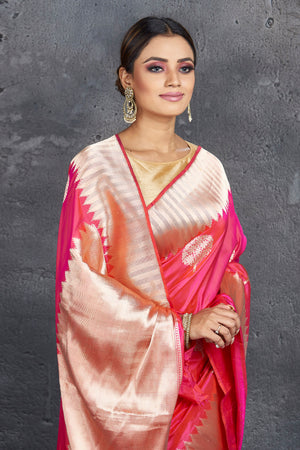 Buy stunning pink Katan silk sari online in USA with golden zari border. Keep your ethnic wardrobe up to date with latest designer sarees, pure silk sarees, handwoven sarees, tussar silk sarees, embroidered sarees from Pure Elegance Indian saree store in USA.-closeup