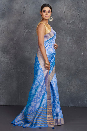 Shop stunning light blue printed raw silk saree online in USA. Be the center of attraction at parties and festive occasions in stunning silk sarees, handwoven sarees, embroidered sarees, designer sarees, Banarasi sarees, tussar silk sarees from Pure Elegance Indian fashion store in USA.-side