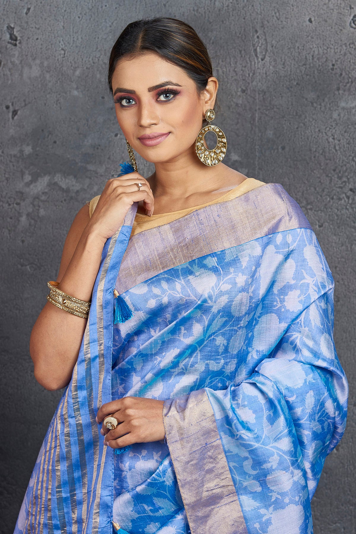 Shop stunning light blue printed raw silk saree online in USA. Be the center of attraction at parties and festive occasions in stunning silk sarees, handwoven sarees, embroidered sarees, designer sarees, Banarasi sarees, tussar silk sarees from Pure Elegance Indian fashion store in USA.-closeup