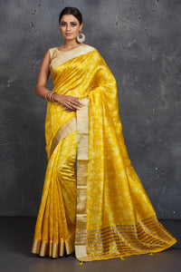 Shop stunning yellow printed printed raw silk sari online in USA with zari border. Be the center of attraction at parties and festive occasions in stunning silk sarees, handwoven sarees, embroidered sarees, designer sarees, Banarasi sarees, tussar silk sarees from Pure Elegance Indian fashion store in USA.-full view