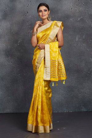 Shop stunning yellow printed printed raw silk sari online in USA with zari border. Be the center of attraction at parties and festive occasions in stunning silk sarees, handwoven sarees, embroidered sarees, designer sarees, Banarasi sarees, tussar silk sarees from Pure Elegance Indian fashion store in USA.-side