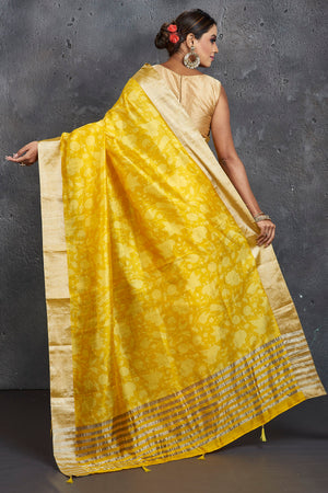 Shop stunning yellow printed printed raw silk sari online in USA with zari border. Be the center of attraction at parties and festive occasions in stunning silk sarees, handwoven sarees, embroidered sarees, designer sarees, Banarasi sarees, tussar silk sarees from Pure Elegance Indian fashion store in USA.-back