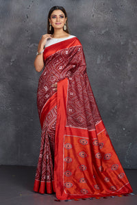Buy stunning maroon ikkat silk saree online in USA with red border and pallu. Keep your ethnic wardrobe up to date with latest designer sarees, pure silk sarees, handwoven sarees, tussar silk sarees, embroidered saris, Paithani sarees from Pure Elegance Indian saree store in USA.-full view