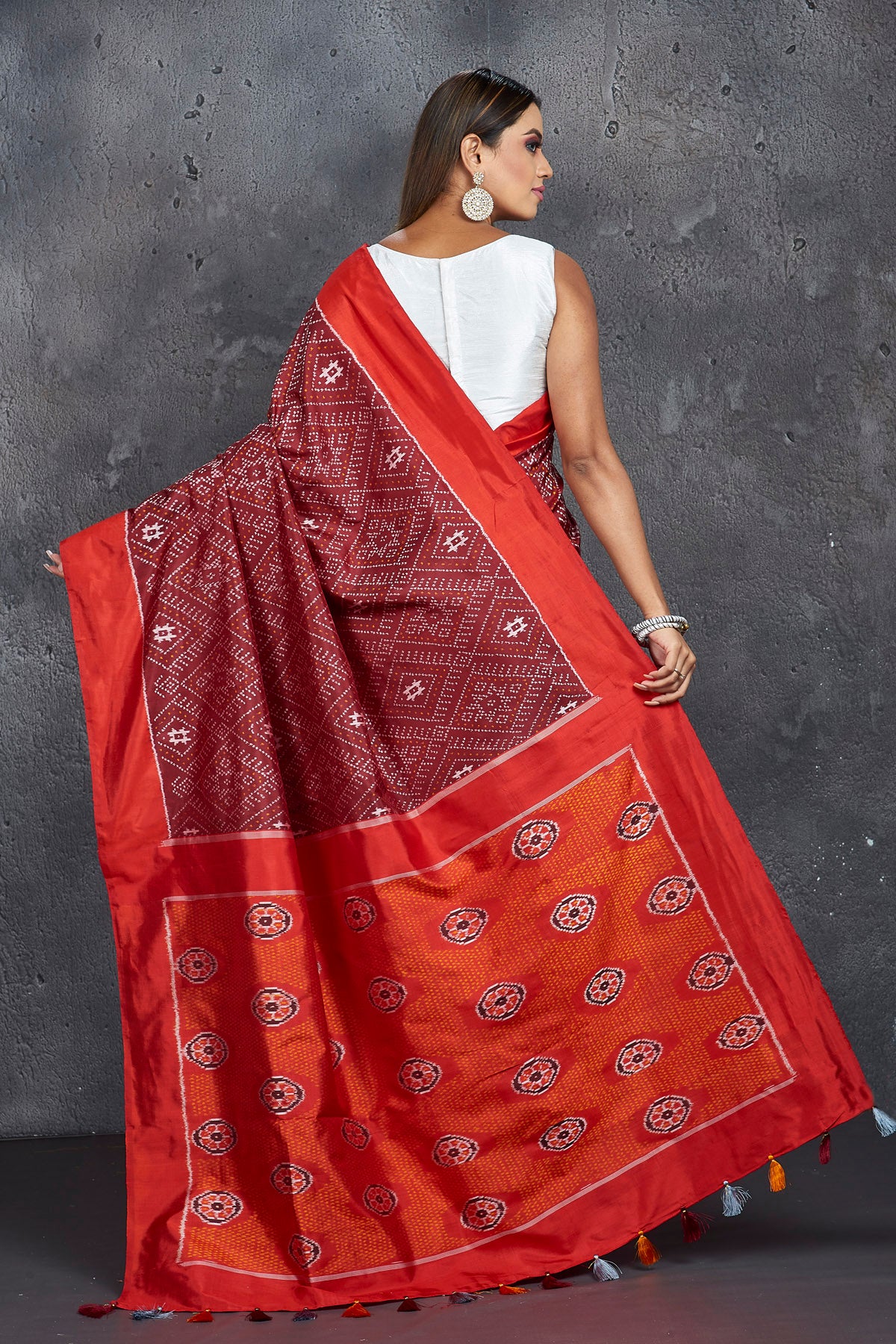 Buy stunning maroon ikkat silk saree online in USA with red border and pallu. Keep your ethnic wardrobe up to date with latest designer sarees, pure silk sarees, handwoven sarees, tussar silk sarees, embroidered saris, Paithani sarees from Pure Elegance Indian saree store in USA.-back