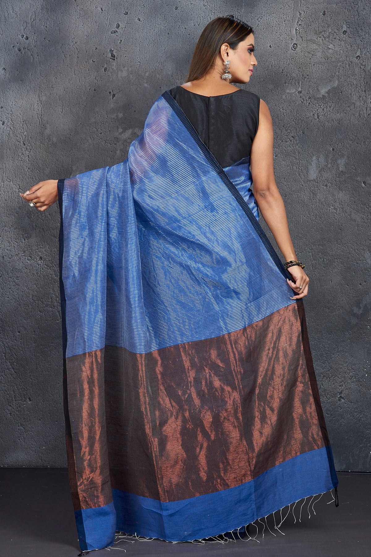 Shop elegant blue silk linen saree online in USA with zari pallu. Keep your ethnic wardrobe up to date with latest designer sarees, pure silk sarees, handwoven sarees, tussar silk sarees, embroidered saris, Paithani sarees from Pure Elegance Indian saree store in USA.-back