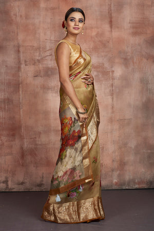 Buy gorgeous beige floral organza saree online in USA with zari border. Keep your ethnic wardrobe up to date with latest designer sarees, pure silk sarees, handwoven sarees, tussar silk sarees, embroidered sarees from Pure Elegance Indian saree store in USA.-side
