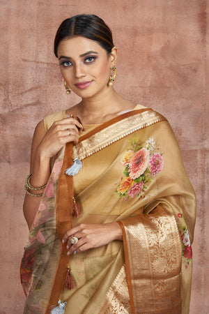 Buy gorgeous beige floral organza saree online in USA with zari border. Keep your ethnic wardrobe up to date with latest designer sarees, pure silk sarees, handwoven sarees, tussar silk sarees, embroidered sarees from Pure Elegance Indian saree store in USA.-closeup