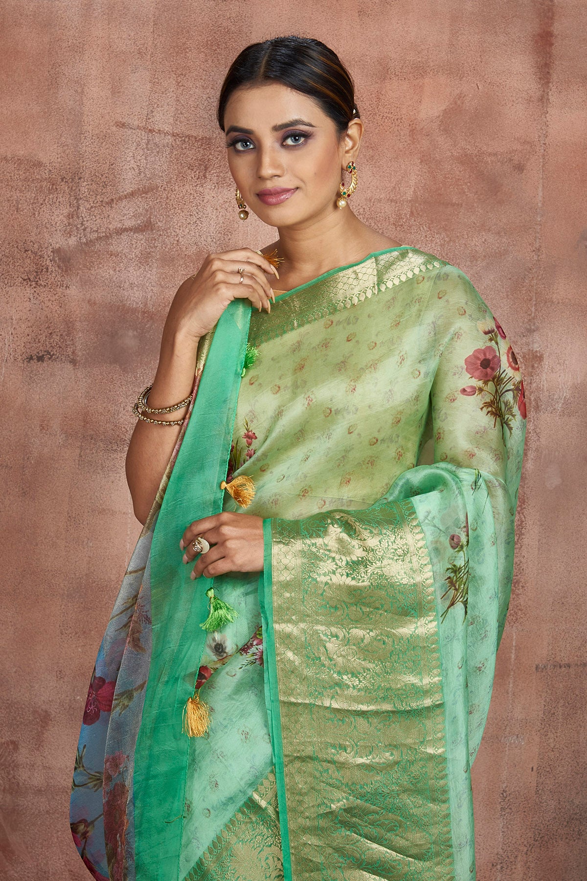 Shop beautiful pastel green floral organza saree online in USA with zari border. Keep your ethnic wardrobe up to date with latest designer sarees, pure silk sarees, handwoven sarees, tussar silk sarees, embroidered sarees from Pure Elegance Indian saree store in USA.-closeup