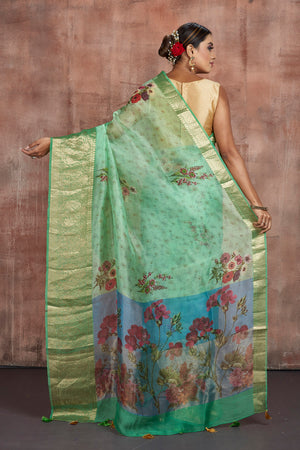 Shop beautiful pastel green floral organza saree online in USA with zari border. Keep your ethnic wardrobe up to date with latest designer sarees, pure silk sarees, handwoven sarees, tussar silk sarees, embroidered sarees from Pure Elegance Indian saree store in USA.-back