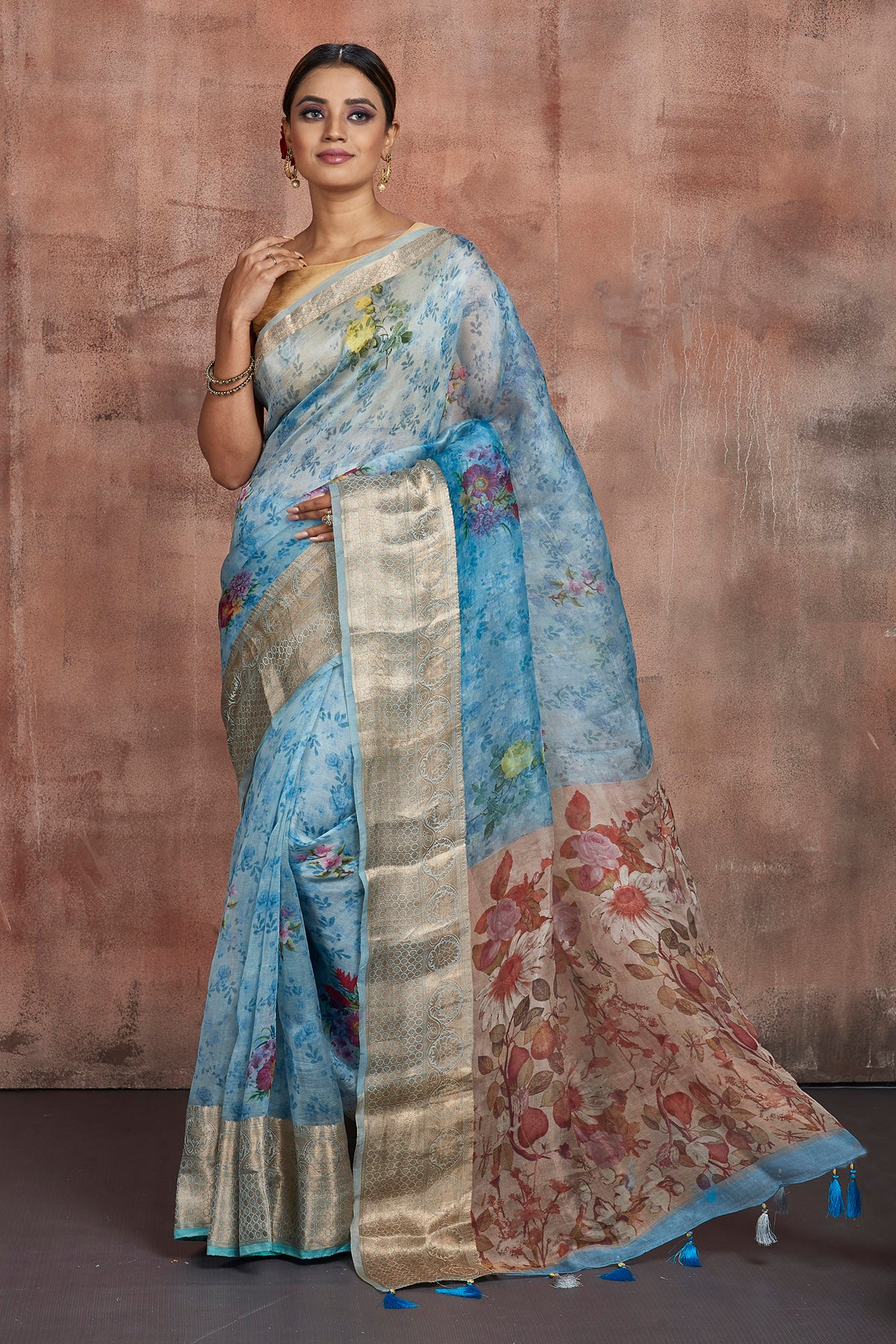 Buy stunning blue floral organza sari online in USA with golden zari green border. Keep your ethnic wardrobe up to date with latest designer sarees, pure silk sarees, handwoven sarees, tussar silk sarees, embroidered sarees from Pure Elegance Indian saree store in USA.-full view