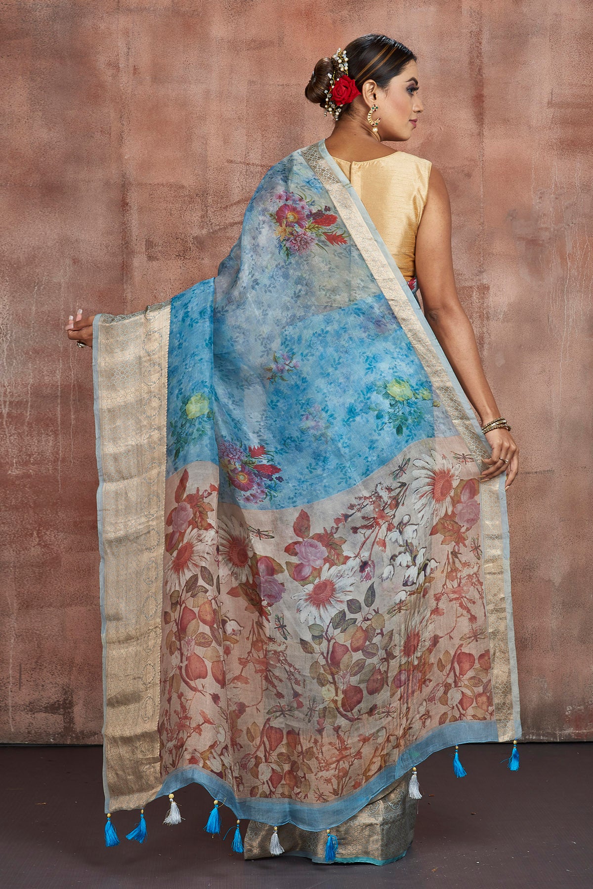 Buy stunning blue floral organza sari online in USA with golden zari green border. Keep your ethnic wardrobe up to date with latest designer sarees, pure silk sarees, handwoven sarees, tussar silk sarees, embroidered sarees from Pure Elegance Indian saree store in USA.-back