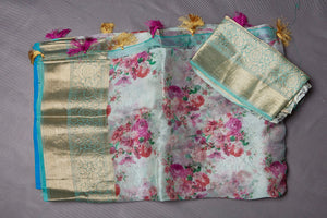 Buy beautiful powder blue floral organza saree online in USA with golden zari green border. Keep your ethnic wardrobe up to date with latest designer sarees, pure silk sarees, handwoven sarees, tussar silk sarees, embroidered sarees from Pure Elegance Indian saree store in USA.-blouse