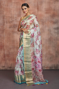 Buy beautiful powder blue floral organza saree online in USA with golden zari green border. Keep your ethnic wardrobe up to date with latest designer sarees, pure silk sarees, handwoven sarees, tussar silk sarees, embroidered sarees from Pure Elegance Indian saree store in USA.-full view