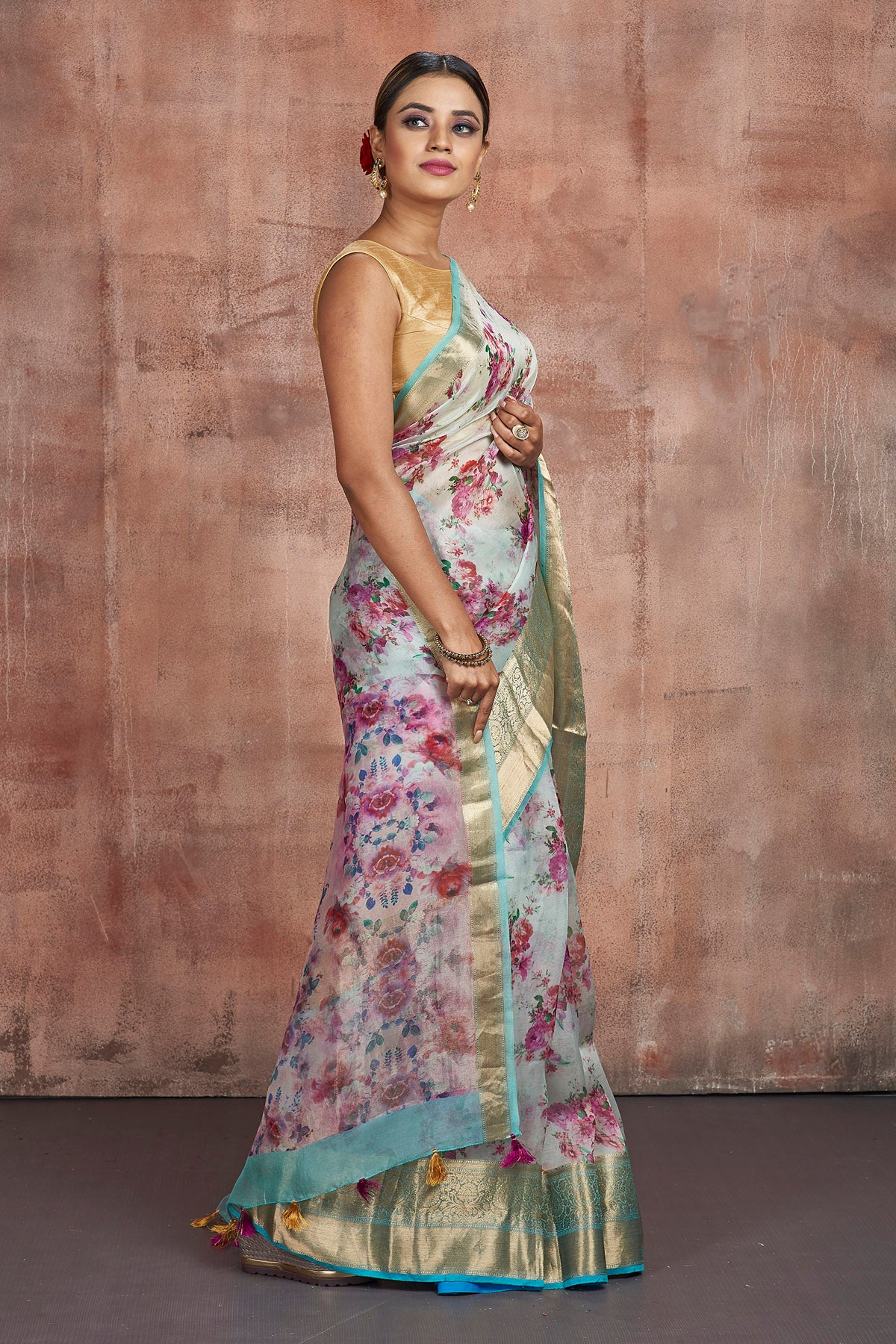 Buy beautiful powder blue floral organza saree online in USA with golden zari green border. Keep your ethnic wardrobe up to date with latest designer sarees, pure silk sarees, handwoven sarees, tussar silk sarees, embroidered sarees from Pure Elegance Indian saree store in USA.-side