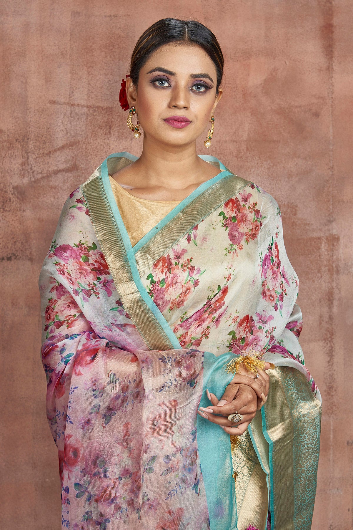 Buy beautiful powder blue floral organza saree online in USA with golden zari green border. Keep your ethnic wardrobe up to date with latest designer sarees, pure silk sarees, handwoven sarees, tussar silk sarees, embroidered sarees from Pure Elegance Indian saree store in USA.-closeup