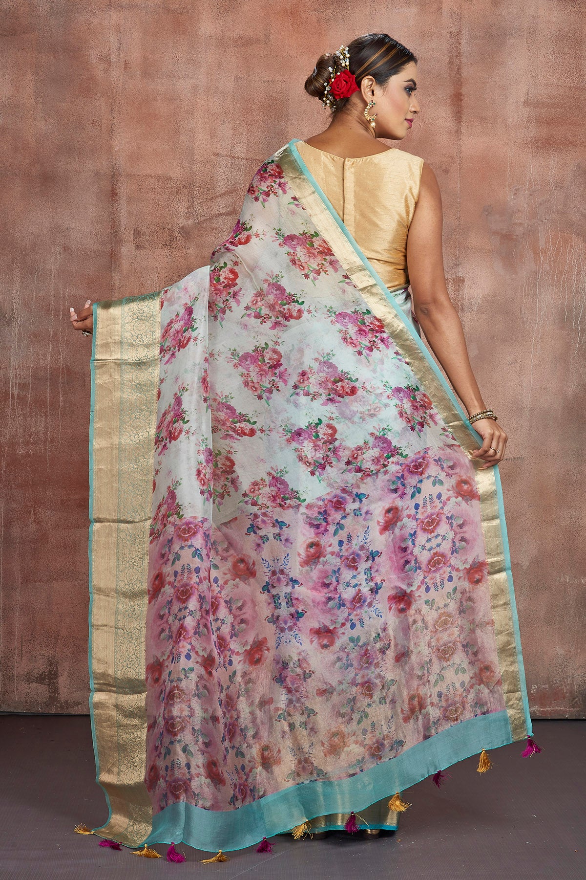 Buy beautiful powder blue floral organza saree online in USA with golden zari green border. Keep your ethnic wardrobe up to date with latest designer sarees, pure silk sarees, handwoven sarees, tussar silk sarees, embroidered sarees from Pure Elegance Indian saree store in USA.-back
