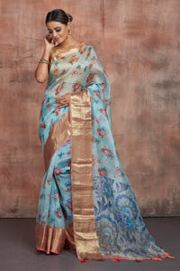 Buy beautiful light blue floral print organza saree online in USA with zari border. Keep your ethnic wardrobe up to date with latest designer sarees, pure silk sarees, handwoven sarees, tussar silk sarees, embroidered sarees from Pure Elegance Indian saree store in USA.-full view