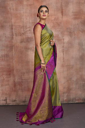 Shop stunning pista green Kanjivaram saree online in USA with purple border with buta. Keep your ethnic wardrobe up to date with latest designer sarees, pure silk sarees, handwoven sarees, tussar silk sarees, embroidered sarees from Pure Elegance Indian saree store in USA.-side