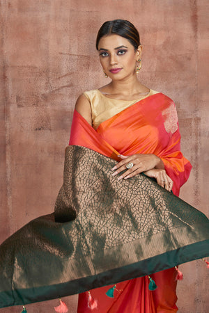 Shop beautiful orange borderless Kanjivaram saree online in USA with dark green zari pallu. Keep your ethnic wardrobe up to date with latest designer sarees, pure silk sarees, handwoven sarees, tussar silk sarees, embroidered sarees from Pure Elegance Indian saree store in USA.-closeup
