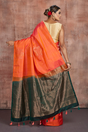 Shop beautiful orange borderless Kanjivaram saree online in USA with dark green zari pallu. Keep your ethnic wardrobe up to date with latest designer sarees, pure silk sarees, handwoven sarees, tussar silk sarees, embroidered sarees from Pure Elegance Indian saree store in USA.-back