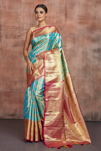 Buy beautiful pastel blue Kanjivaram silk saree online in USA with golden zari border. Keep your ethnic wardrobe up to date with latest designer sarees, pure silk sarees, handwoven sarees, tussar silk sarees, embroidered sarees from Pure Elegance Indian saree store in USA.-full view