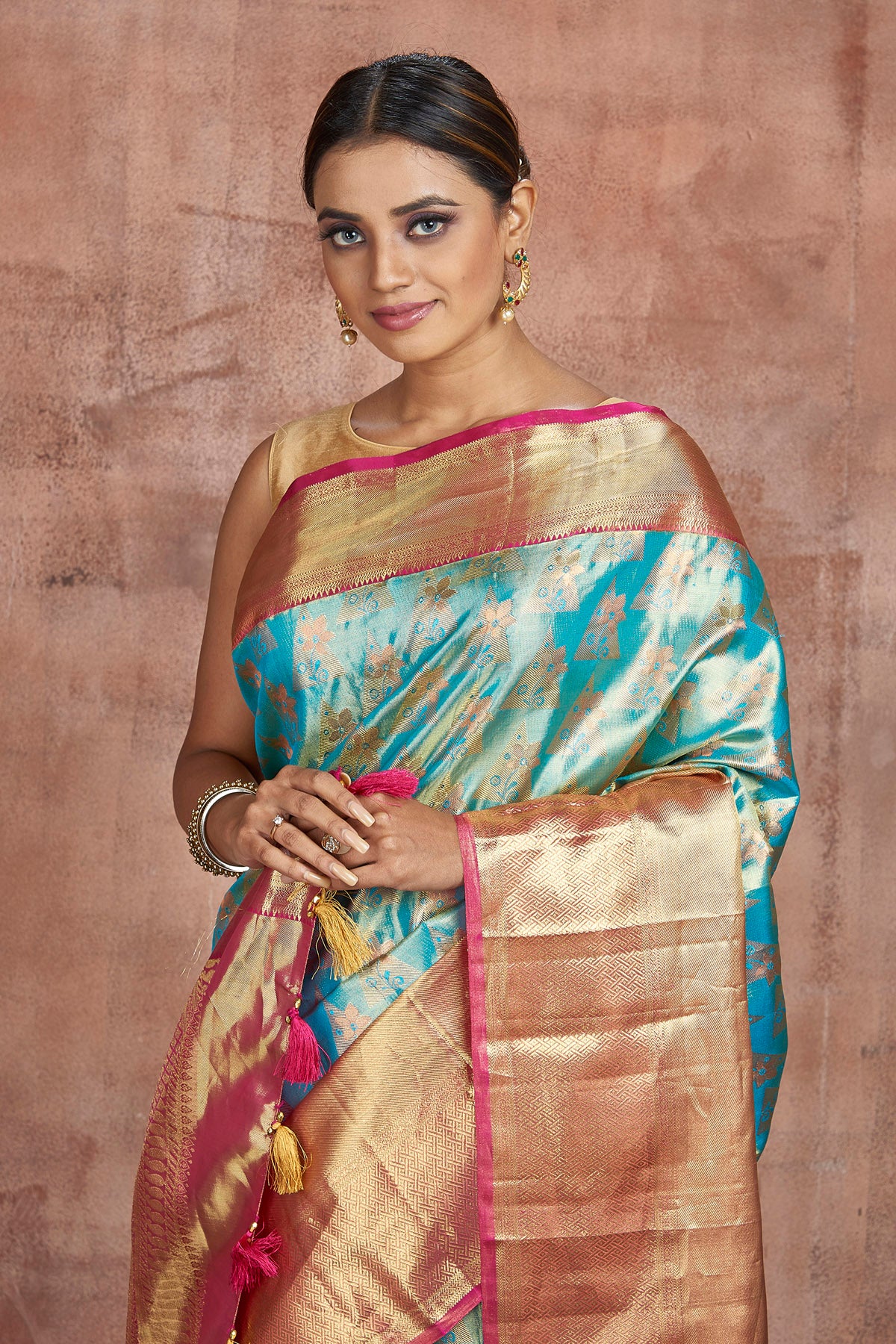 Buy beautiful pastel blue Kanjivaram silk saree online in USA with golden zari border. Keep your ethnic wardrobe up to date with latest designer sarees, pure silk sarees, handwoven sarees, tussar silk sarees, embroidered sarees from Pure Elegance Indian saree store in USA.-closeup