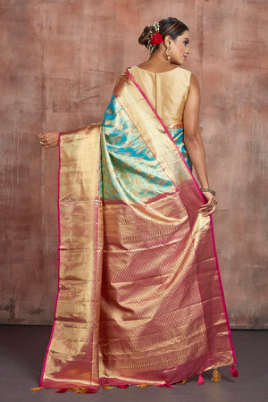 Buy beautiful pastel blue Kanjivaram silk saree online in USA with golden zari border. Keep your ethnic wardrobe up to date with latest designer sarees, pure silk sarees, handwoven sarees, tussar silk sarees, embroidered sarees from Pure Elegance Indian saree store in USA.-back