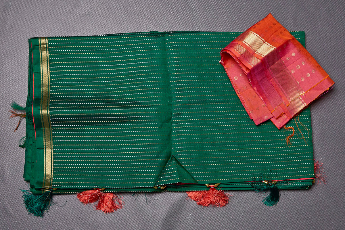 Shop stunning dark green Kanjivaram silk saree online in USA with pink zari pallu. Keep your ethnic wardrobe up to date with latest designer sarees, pure silk sarees, handwoven sarees, tussar silk sarees, embroidered sarees from Pure Elegance Indian saree store in USA.-blouse