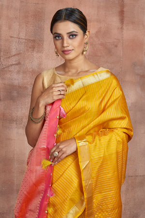Shop beautiful mustard Kanjivaram silk sari online in USA with pink zari pallu. Keep your ethnic wardrobe up to date with latest designer sarees, pure silk sarees, handwoven sarees, tussar silk sarees, embroidered sarees from Pure Elegance Indian saree store in USA.-closeup