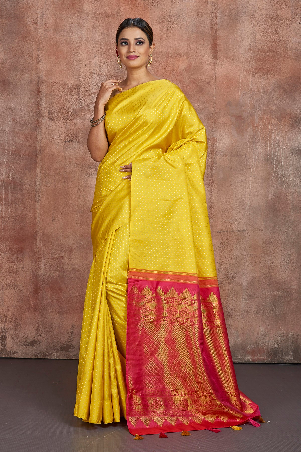 Shop beautiful yellow Kanjivaram silk sari online in USA with pink zari pallu. Keep your ethnic wardrobe up to date with latest designer sarees, pure silk sarees, handwoven sarees, tussar silk saris, embroidered sarees from Pure Elegance Indian saree store in USA.-full view