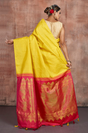 Shop beautiful yellow Kanjivaram silk sari online in USA with pink zari pallu. Keep your ethnic wardrobe up to date with latest designer sarees, pure silk sarees, handwoven sarees, tussar silk saris, embroidered sarees from Pure Elegance Indian saree store in USA.-back