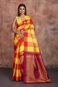 Shop yellow and red check Kanjeevaram saree online in USA with zari pallu. Keep your ethnic wardrobe up to date with latest designer sarees, pure silk sarees, handwoven sarees, tussar silk sarees, embroidered sarees from Pure Elegance Indian saree store in USA.-full view