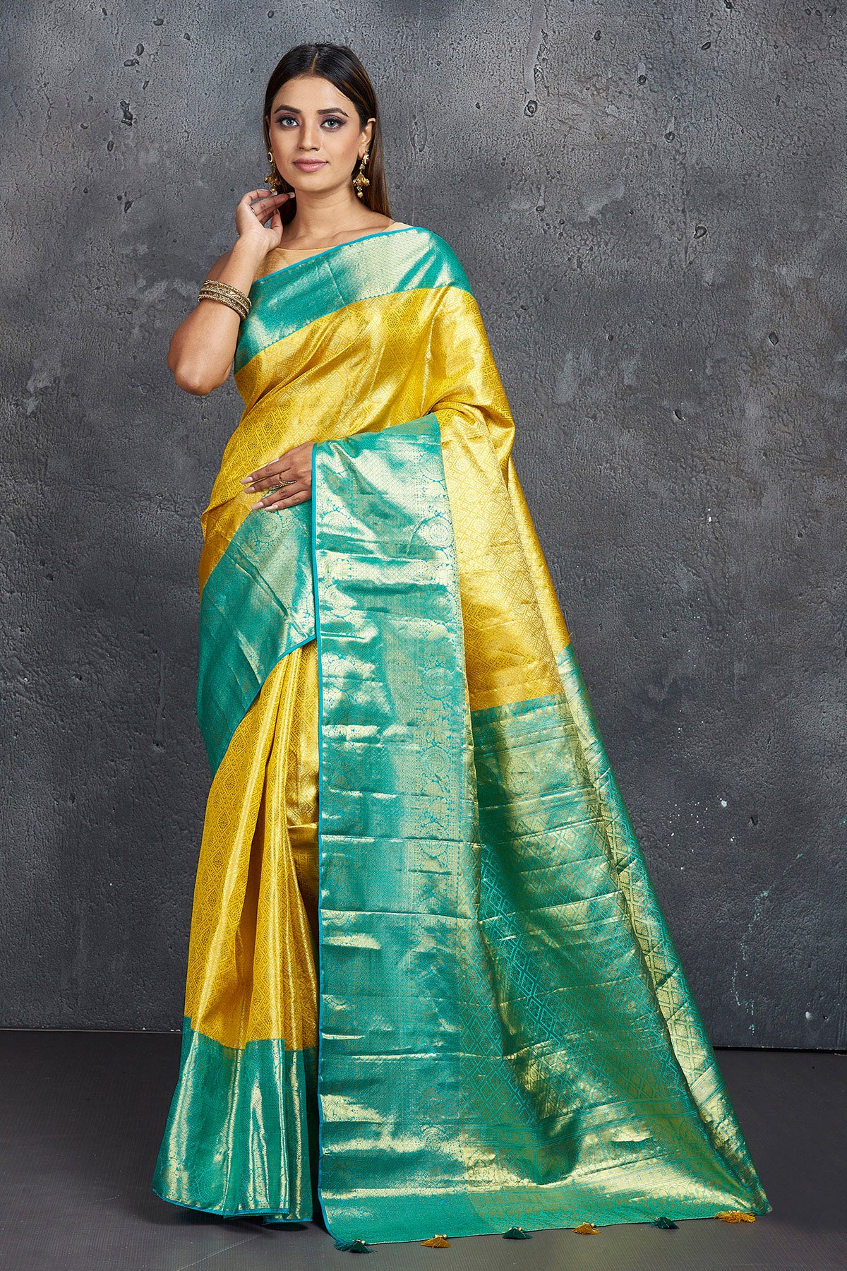 Buy beautiful yellow Kanjeevaram saree online in USA with blue zari border. Keep your ethnic wardrobe up to date with latest designer sarees, pure silk sarees, Kanchipuram silk sarees, handwoven sarees, tussar silk sarees, embroidered sarees from Pure Elegance Indian saree store in USA.-full view