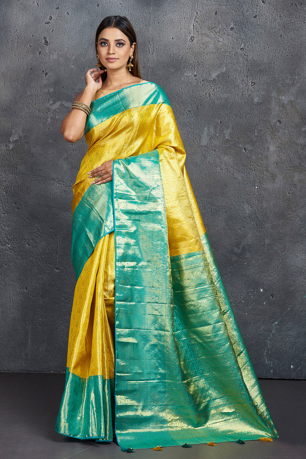 Buy beautiful yellow Kanjeevaram saree online in USA with blue zari border. Keep your ethnic wardrobe up to date with latest designer sarees, pure silk sarees, Kanchipuram silk sarees, handwoven sarees, tussar silk sarees, embroidered sarees from Pure Elegance Indian saree store in USA.-full view