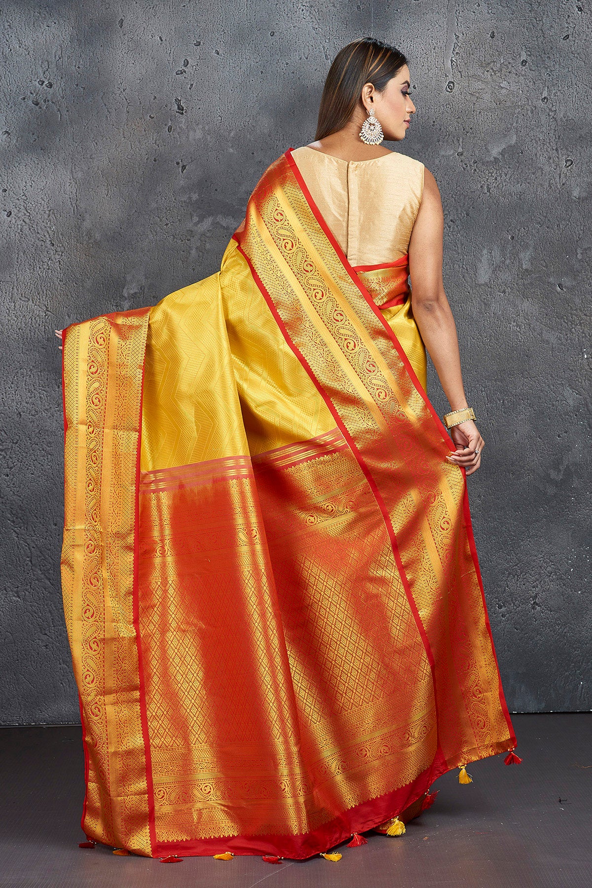 Shop stunning yellow Kanjeevaram silk saree online in USA with red zari border. Keep your ethnic wardrobe up to date with latest designer sarees, pure silk sarees, Kanchipuram silk sarees, handwoven sarees, tussar silk sarees, embroidered sarees from Pure Elegance Indian saree store in USA.-back