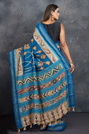 Shop stunning blue pen Kalamkari saree online in USA with blue border. Keep your ethnic wardrobe up to date with latest designer sarees, pure silk sarees, Kanchipuram silk sarees, handwoven sarees, tussar silk sarees, embroidered sarees from Pure Elegance Indian saree store in USA.-back