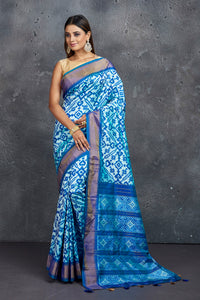 Buy stunning light blue ikkat silk saree online in USA with blue zari border. Keep your ethnic wardrobe up to date with latest designer sarees, pure silk sarees, Kanchipuram silk sarees, handwoven sarees, tussar silk sarees, embroidered sarees from Pure Elegance Indian saree store in USA.-full view