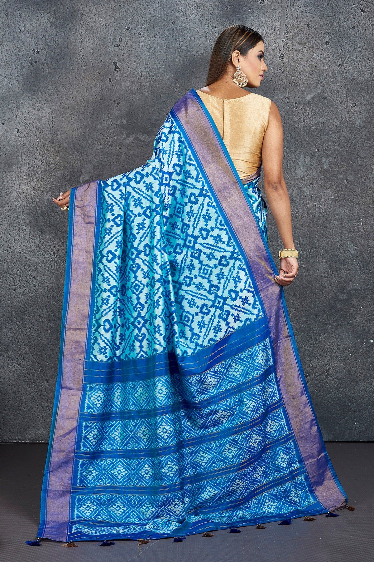 Buy stunning light blue ikkat silk saree online in USA with blue zari border. Keep your ethnic wardrobe up to date with latest designer sarees, pure silk sarees, Kanchipuram silk sarees, handwoven sarees, tussar silk sarees, embroidered sarees from Pure Elegance Indian saree store in USA.-back
