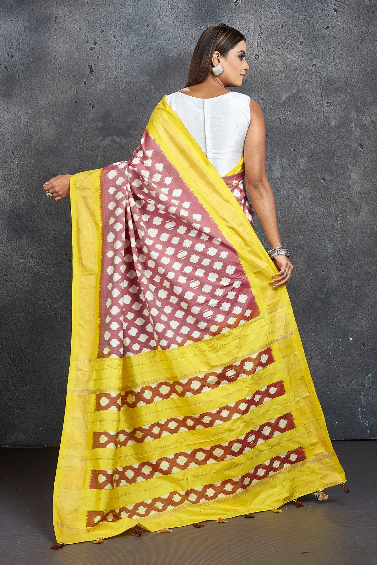 Shop beautiful brown ikkat silk saree online in USA with yellow zari border. Keep your ethnic wardrobe up to date with latest designer sarees, pure silk sarees, Kanchipuram silk sarees, handwoven sarees, tussar silk sarees, embroidered sarees from Pure Elegance Indian saree store in USA.-back